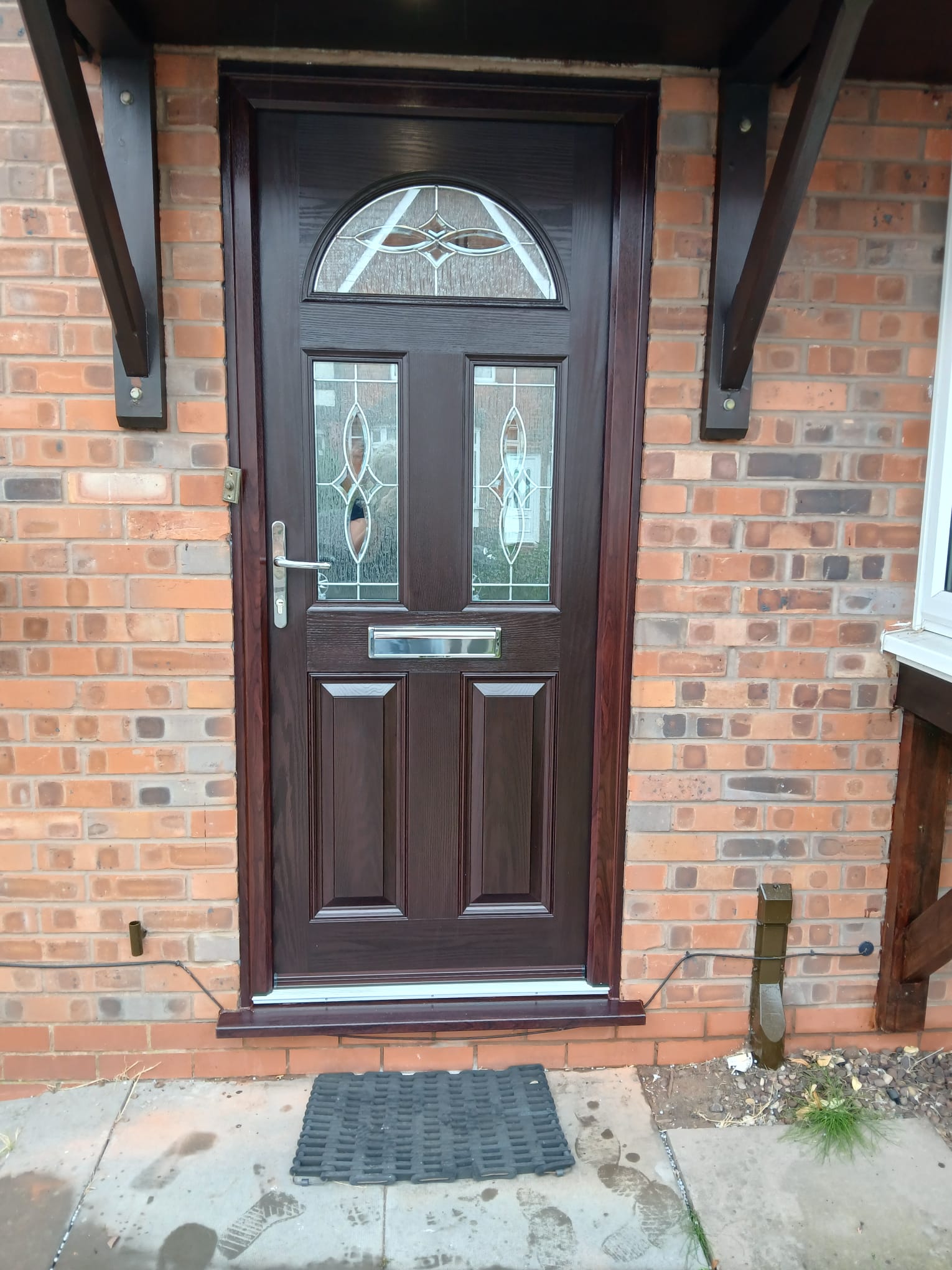 Rosewood composite front door with arched glazing